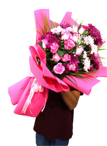 Deep purple flower bouquet in pink wrapping, flower delivery Dubai