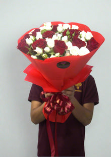 Red roses with white spray roses in red wrapping, roses Dubai