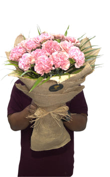Pink carnations in jute wrapping, flower delivery Dubai
