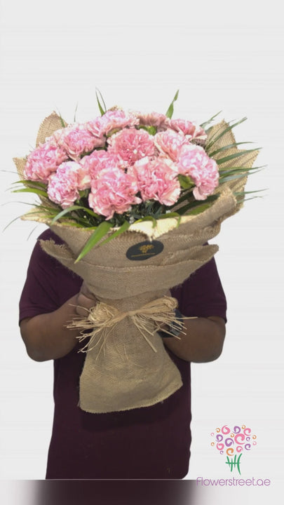 Pink carnations in natural jute wrapping