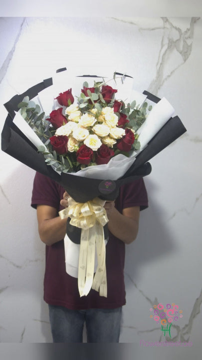 Red roses and cream peach roses in black and white wrapping