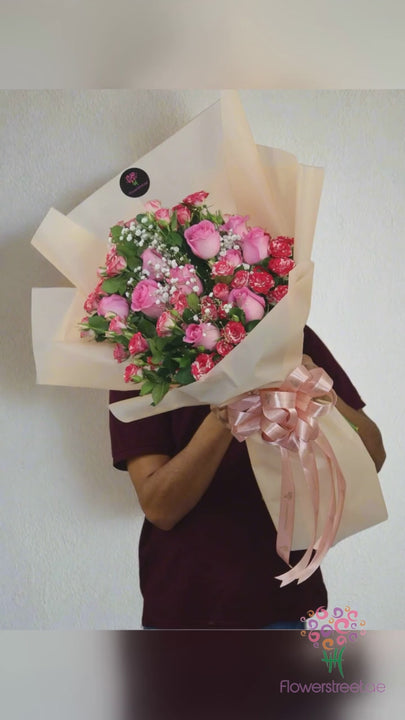Pink and two-tone pink roses with baby's breath bouquet