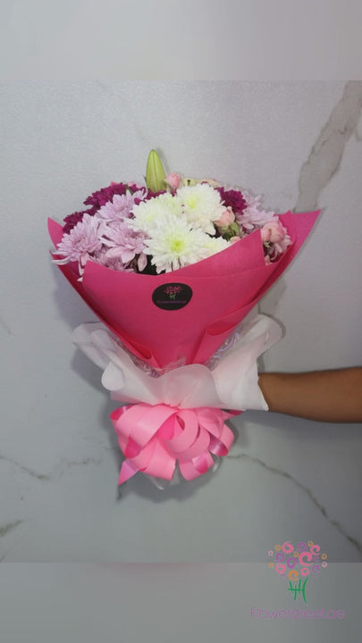 Pink and white chrysanthemums in pink and white double wrapping