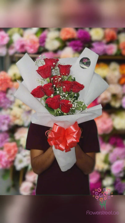 Ten red roses in white wrapping bouquet