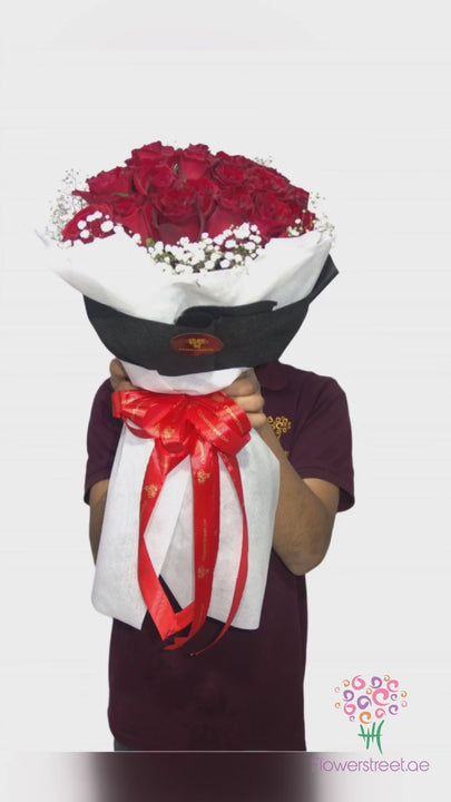Thirty red roses with baby's breath in black and white wrapping