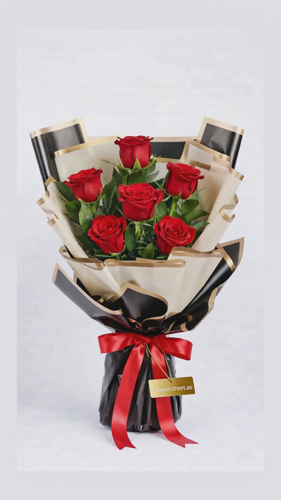 Sweet Love Red Roses bouquet — slow cinematic close-up of seven red roses in cream and black gold-edged wrapping with a red satin ribbon