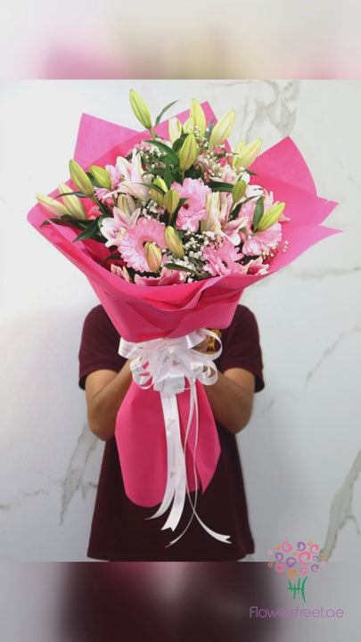 Pink lilies and pink gerberas in bright pink wrapping