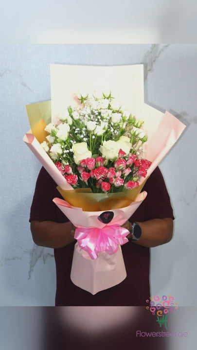 Pink spray roses with white blooms in pink and gold wrapping