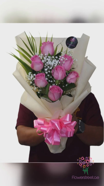 Seven pink roses in beige wrapping bouquet