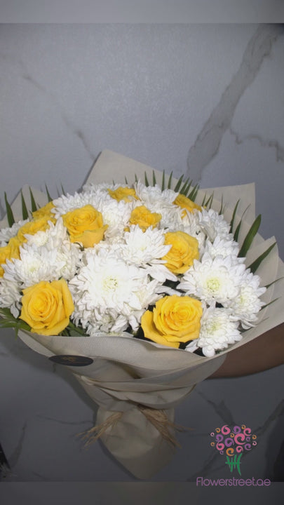 Yellow roses and white chrysanthemums in beige wrapping
