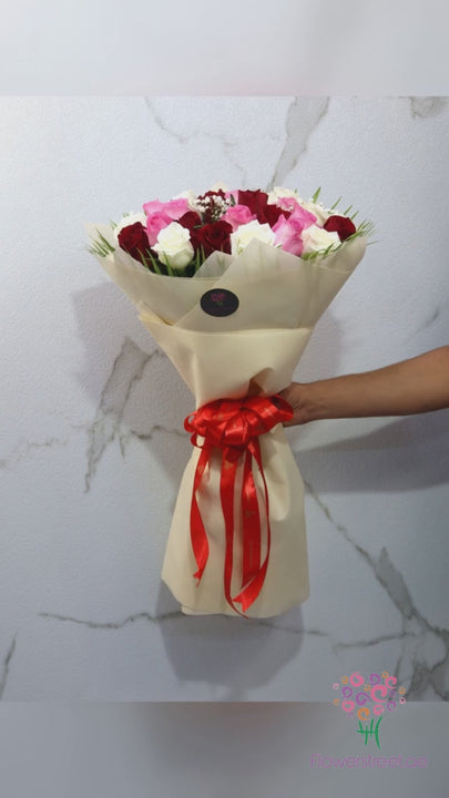 Thirty red, pink and white roses in cream wrapping