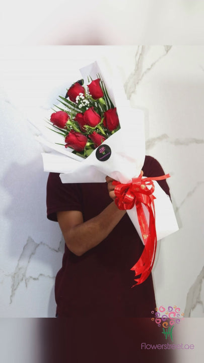 Eight red roses in crisp white wrapping