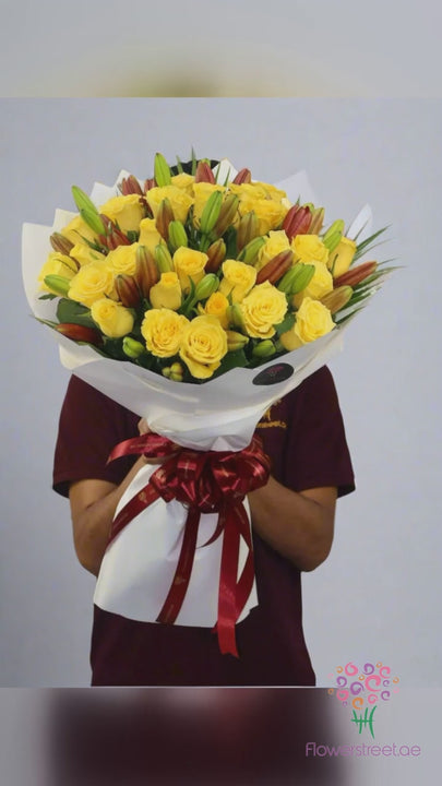 Yellow roses and red lilies bouquet